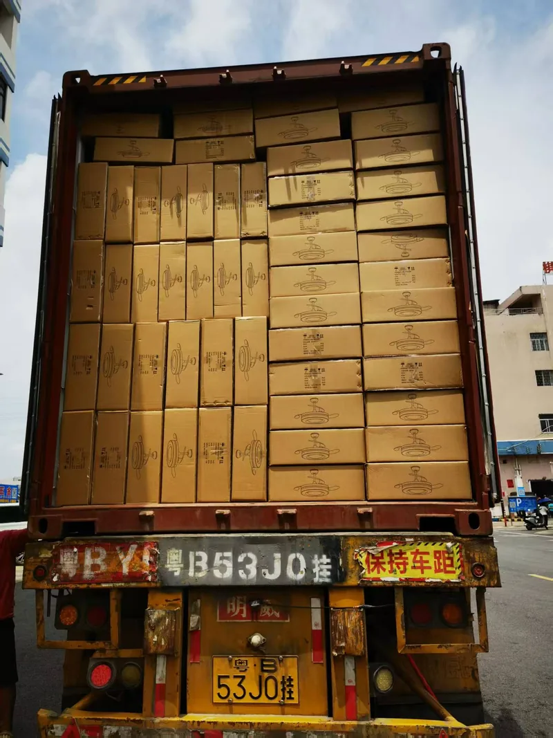 Printed cartons for ceiling fan lights stacked in ranks awaiting loading